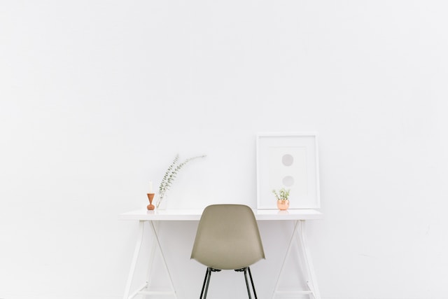 the use of white space in this photo draws attention to the the simple elegance of this desk.