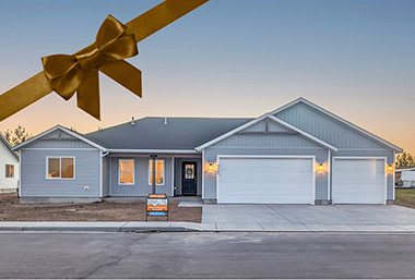 evening sunset ranch home with lights on and brown bow over corner of photo