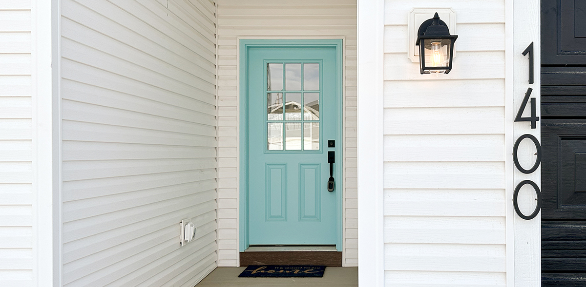 White home exterior with a bright blue door 