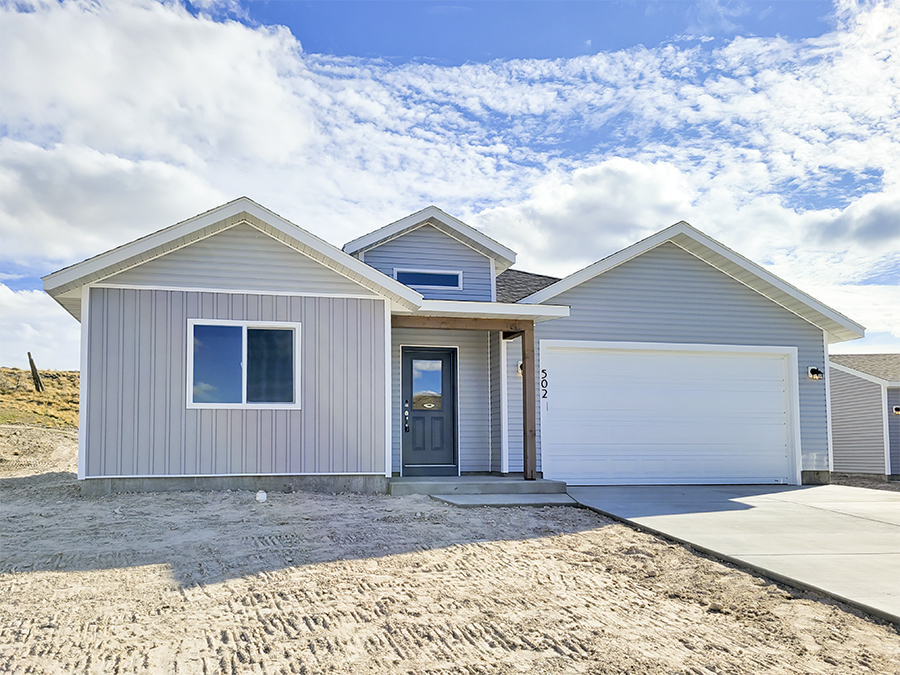 Exterior Photo of the Charming craftsman style single-story home by Smart Dwellings for sale on 502 Rodeo Ct in Rawlins WY Grey with White trim and 2-car garage